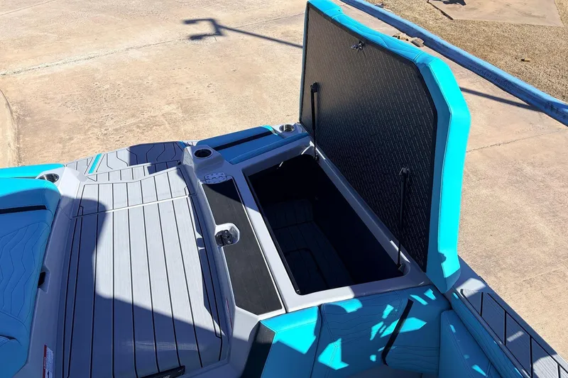 Slide: The Image of 2026 Nautique Super Air Nautique G23 boat with open storage compartment, showcasing sleek design. - 52