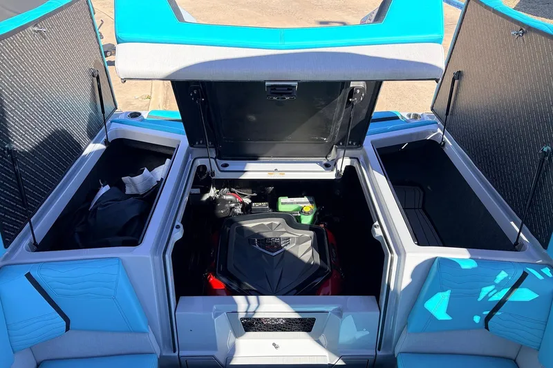 Slide: The Image of 2026 Nautique Super Air Nautique G23 engine compartment with open storage hatches. - 54