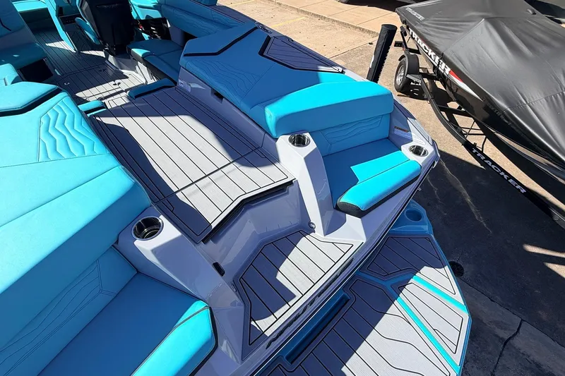 Slide: The Image of 2026 Nautique Super Air Nautique G23 boat interior with blue seating and gray flooring. - 57