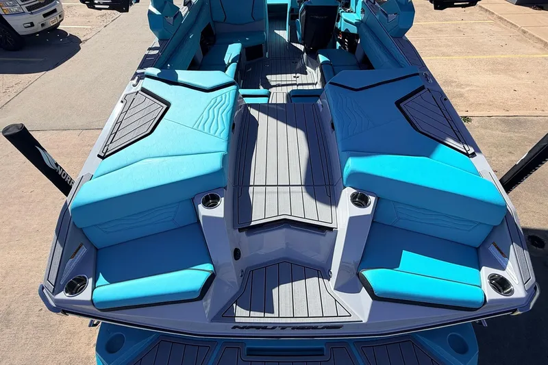 Slide: The Image of 2026 Nautique Super Air Nautique G23 boat with vibrant blue seating and sleek design. - 58
