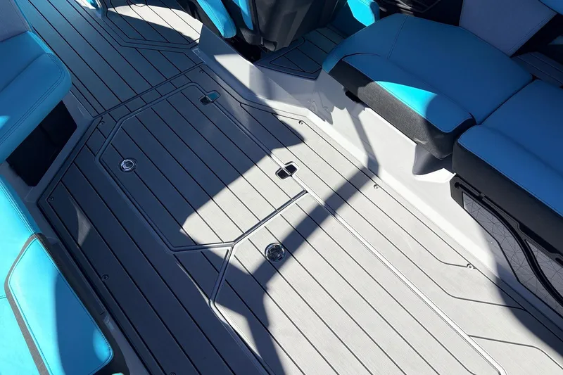 Slide: The Image of 2026 Nautique Super Air Nautique G23 interior with sleek gray flooring and blue seating. - 59