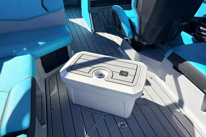 Slide: The Image of Interior of 2026 Nautique Super Air Nautique G23 with blue seating and storage compartment. - 60