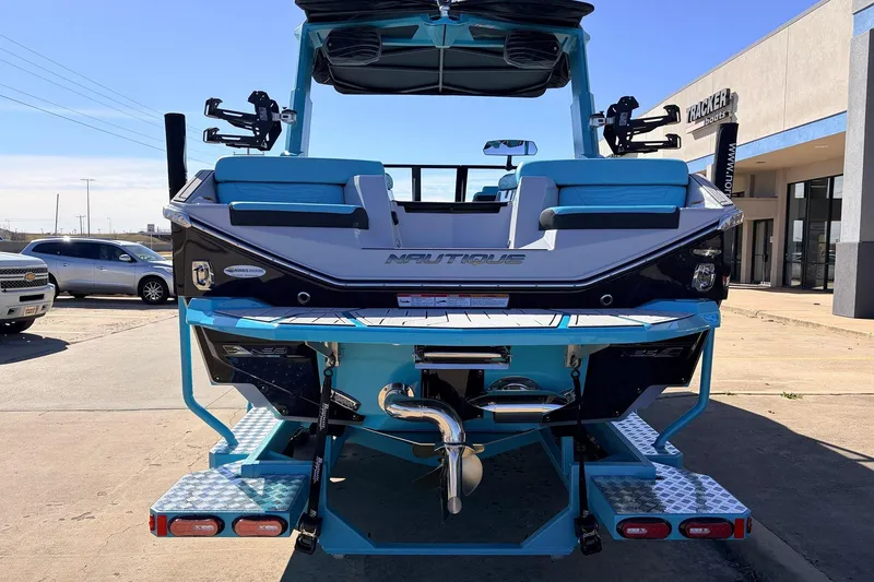 Slide: The Image of 2026 Nautique Super Air Nautique G23 boat, rear view, in a dealership lot. - 9