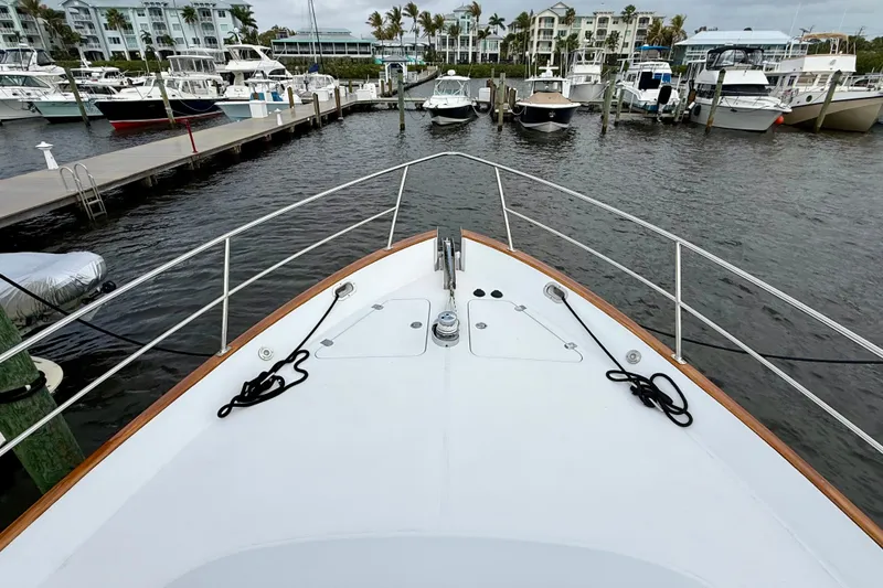 Slide: The Image of Bow view of 2002 Legacy 52 yacht docked at marina with surrounding boats. - 13