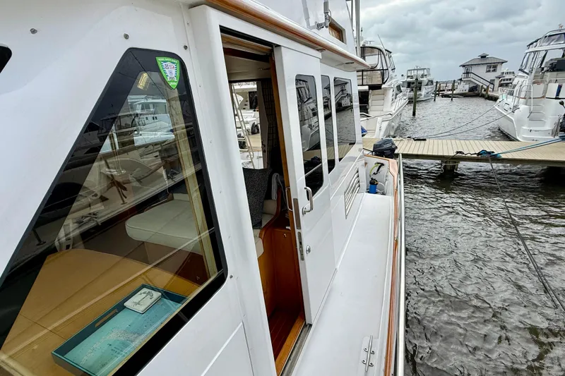 Slide: The Image of 2002 Legacy 52 yacht docked at marina, showcasing sleek design and spacious interior. - 15