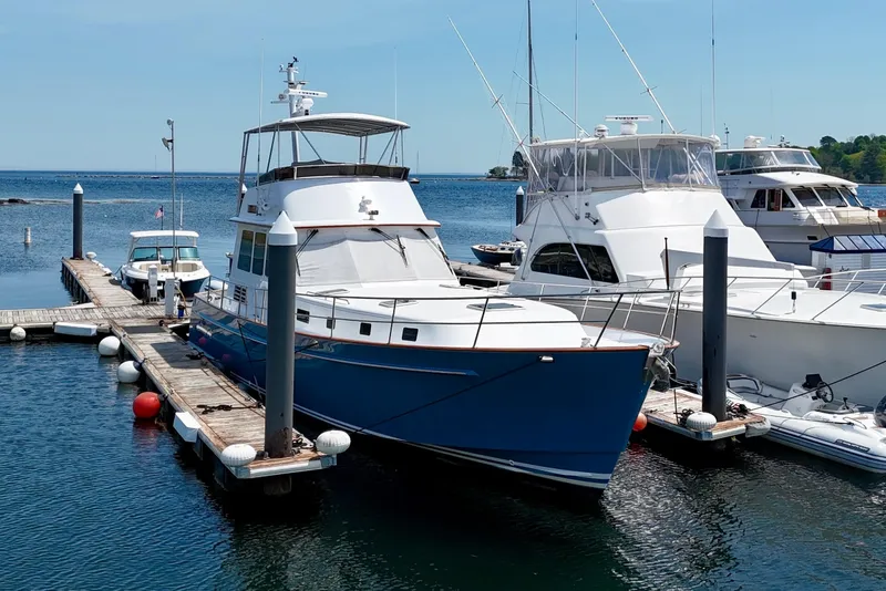 Slide: The Image of Legacy 52 yacht from 2002 docked at a marina, surrounded by other boats. - 2