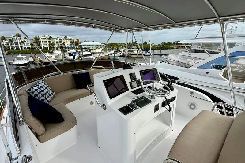 Slide: The Image of Helm of 2002 Legacy 52 yacht with modern controls and comfortable seating at marina. - 21