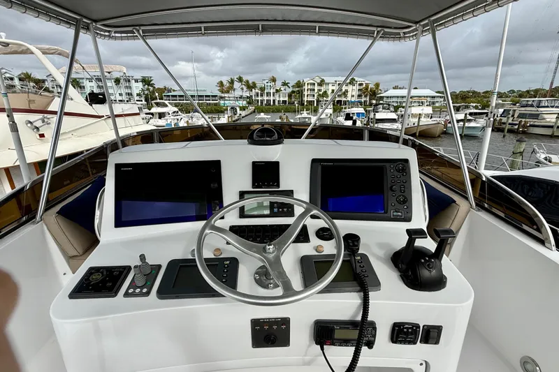 Slide: The Image of Helm of 2002 Legacy 52 yacht with navigation equipment and marina view. - 22