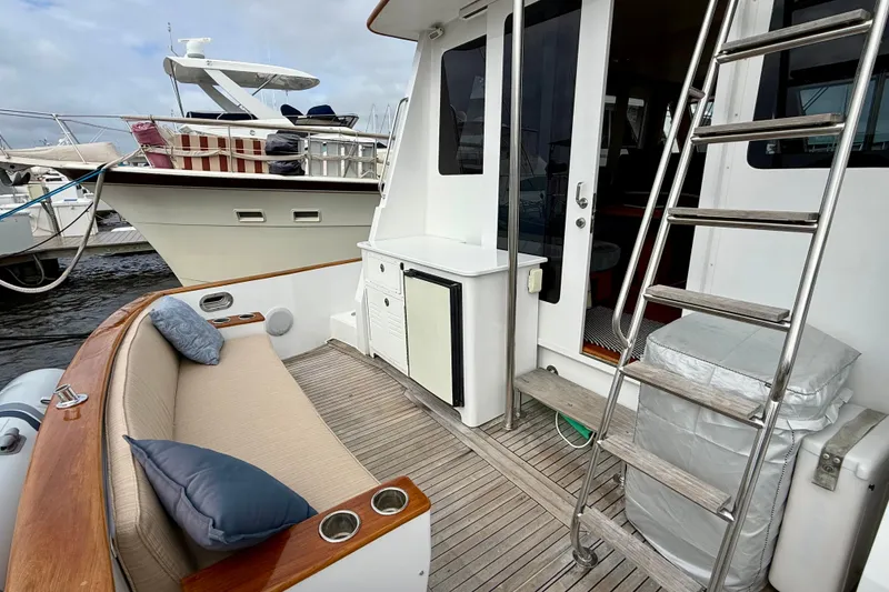 Slide: The Image of Spacious deck of 2002 Legacy 52 yacht with seating and ladder, docked at marina. - 29
