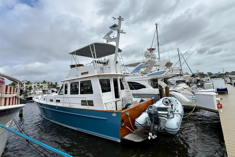 Slide: The Image of Legacy 52 yacht from 2002 docked at marina with inflatable boat attached. - 3