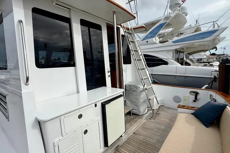 Slide: The Image of 2002 Legacy 52 yacht deck with seating, ladder, and storage compartments. - 30