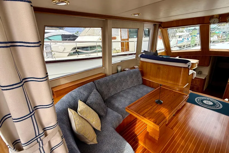 Slide: The Image of Interior of a 2002 Legacy 52 yacht with cozy seating and wooden accents. - 33