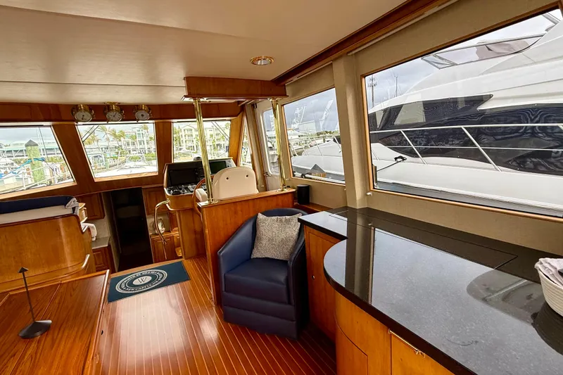 Slide: The Image of Interior of 2002 Legacy 52 yacht with wooden finishes and large windows. - 35