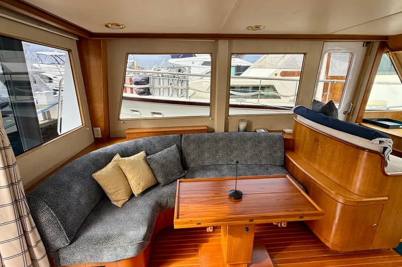 Slide: The Image of Luxurious interior of 2002 Legacy 52 yacht with plush seating and wooden table. - 37
