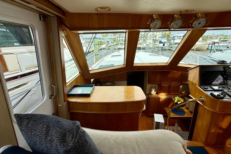 Slide: The Image of Interior of a 2002 Legacy 52 yacht with wooden finishes and large windows. - 41