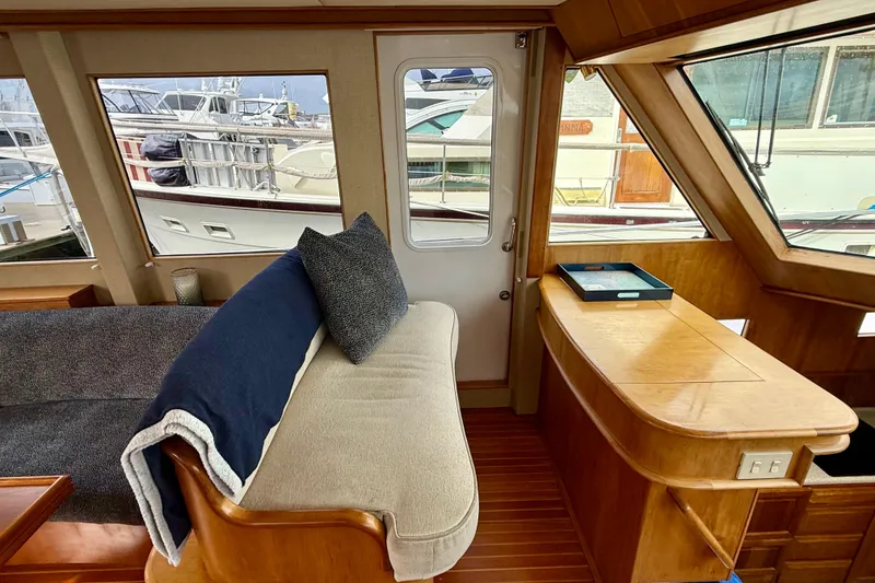 Slide: The Image of Interior of a 2002 Legacy 52 yacht with cozy seating and wooden accents. - 44