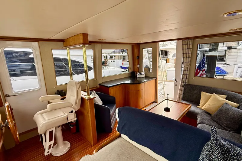 Slide: The Image of Interior of 2002 Legacy 52 yacht with seating, helm chair, and windows. - 46