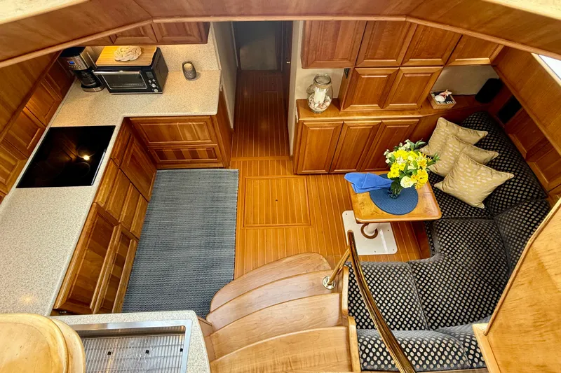Slide: The Image of Luxurious 2002 Legacy 52 yacht interior with wood cabinetry, cozy seating, and modern kitchen amenities. - 48