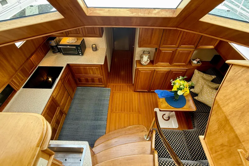 Slide: The Image of Luxurious 2002 Legacy 52 yacht interior with wooden cabinetry, kitchenette, and cozy seating area. - 49