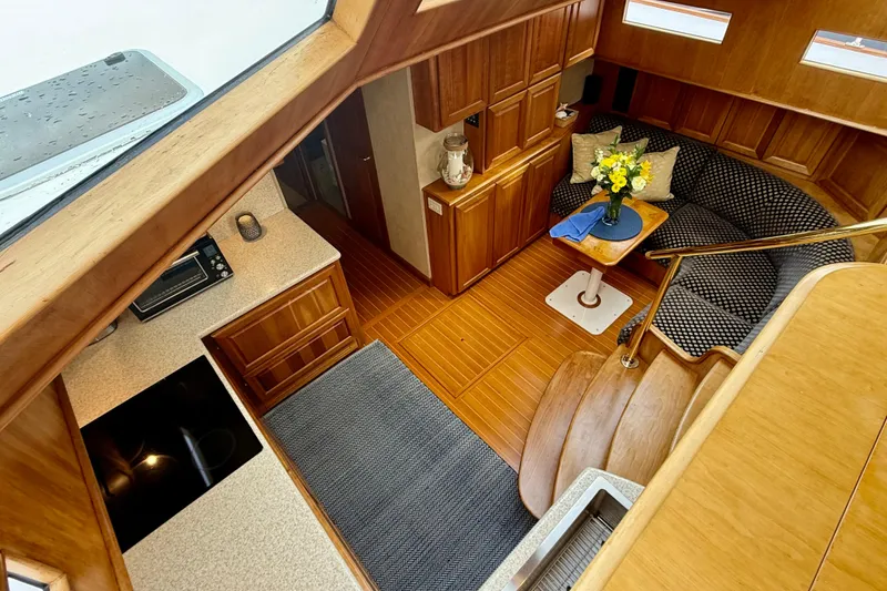 Slide: The Image of Luxurious interior of 2002 Legacy 52 yacht with wood finish and cozy seating area. - 50