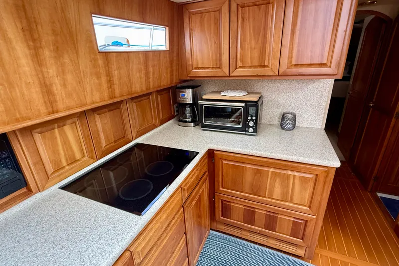 Slide: The Image of Wooden kitchen interior on a 2002 Legacy 52 yacht with modern appliances. - 54