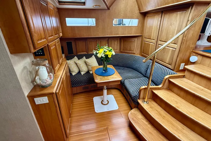Slide: The Image of Luxurious 2002 Legacy 52 yacht interior with wooden cabinetry, cozy seating, and elegant decor. - 55