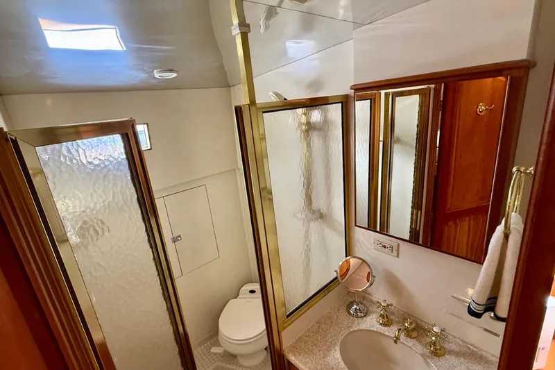 Slide: The Image of Luxurious bathroom in 2002 Legacy 52 yacht with shower, sink, and elegant fixtures. - 57