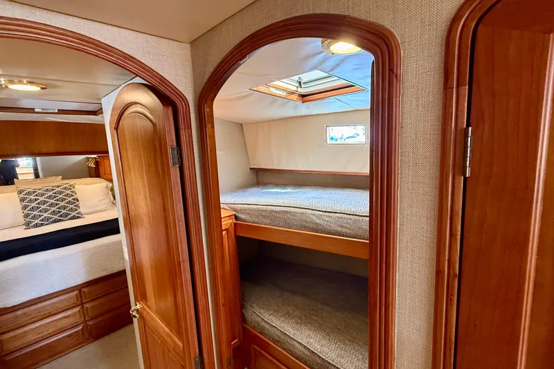 Slide: The Image of Interior of 2002 Legacy 52 yacht with cozy wooden bunk beds and elegant design. - 59