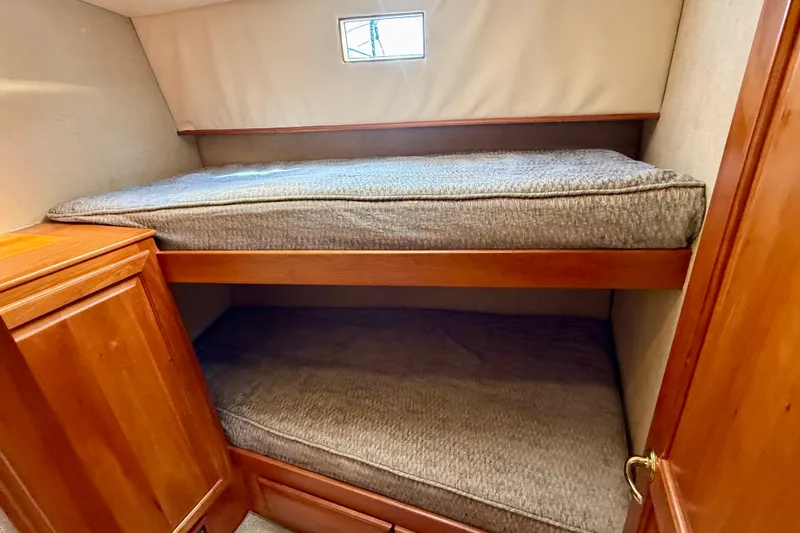 Slide: The Image of Bunk beds in a 2002 Legacy 52 yacht cabin with wooden cabinetry. - 60