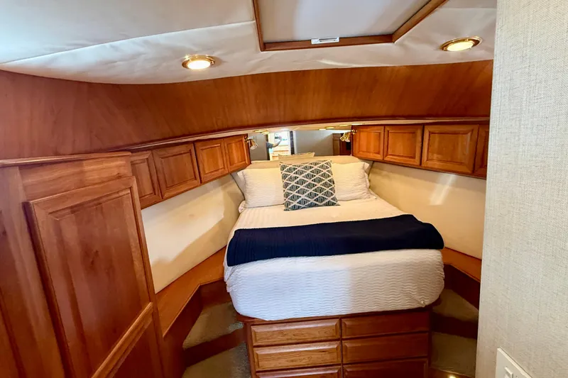 Slide: The Image of Cozy cabin bedroom in 2002 Legacy 52 yacht with wooden cabinetry and soft lighting. - 62