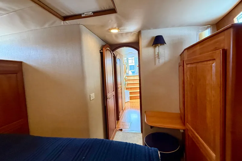 Slide: The Image of Interior of 2002 Legacy 52 yacht with wooden cabinetry and cozy lighting. - 66
