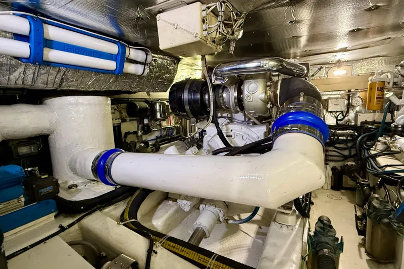 Slide: The Image of Engine room of a 2002 Legacy 52 yacht, featuring complex piping and machinery. - 68