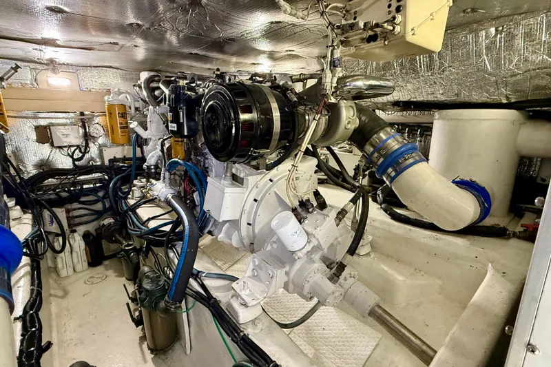 Slide: The Image of Engine room of a 2002 Legacy 52 yacht, showcasing complex machinery and piping. - 69