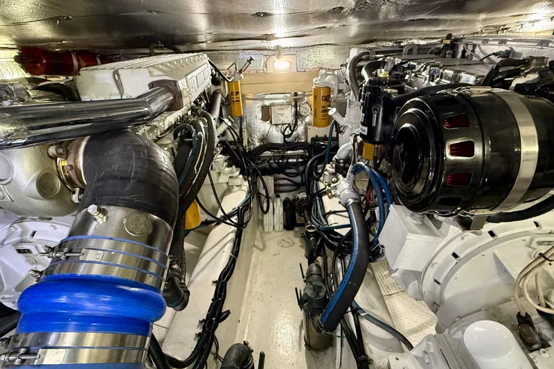 Slide: The Image of Engine room of a 2002 Legacy 52 yacht, showcasing complex machinery and components. - 70