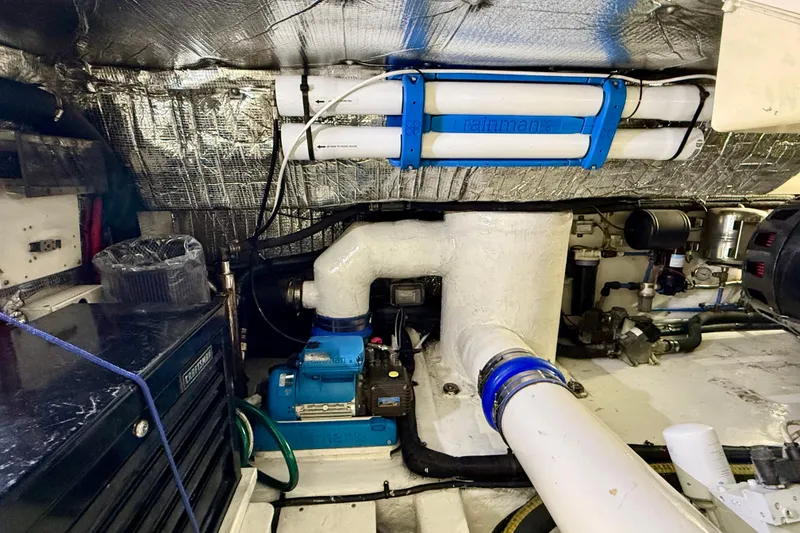 Slide: The Image of Engine room of a 2002 Legacy 52 yacht, featuring mechanical components and insulation. - 71