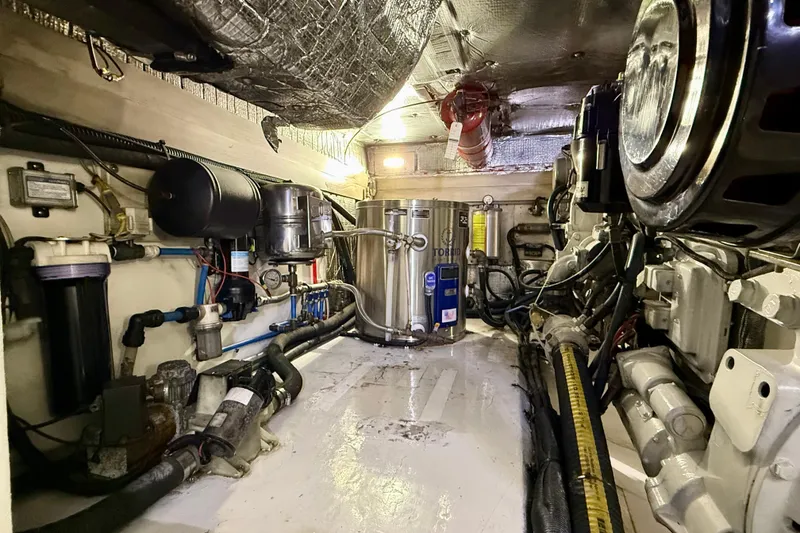 Slide: The Image of Engine room of a 2002 Legacy 52 yacht, showcasing mechanical components and equipment. - 72