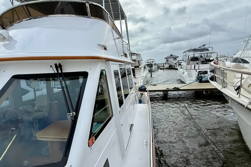 Slide: The Image of Legacy 52 yacht docked at marina, cloudy sky, 2002 model. - 8