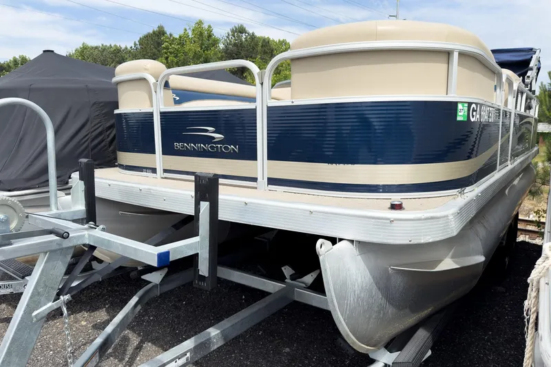 The Image of 2012 Bennington 22 SSL pontoon boat on trailer, blue and beige design. - 15