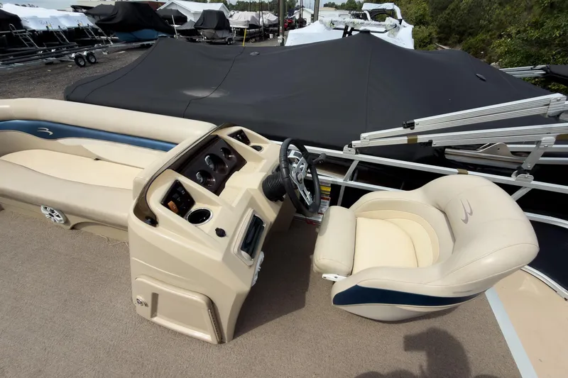 Slide: The Image of 2012 Bennington 22 SSL boat interior with steering console and seating. - 22