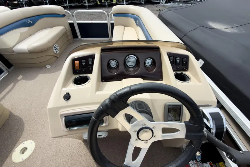 Slide: The Image of Steering console of a 2012 Bennington 22 SSL pontoon boat with beige interior. - 23