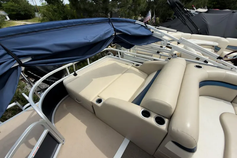 Slide: The Image of 2012 Bennington 22 SSL pontoon boat with beige seating and blue canopy. - 24