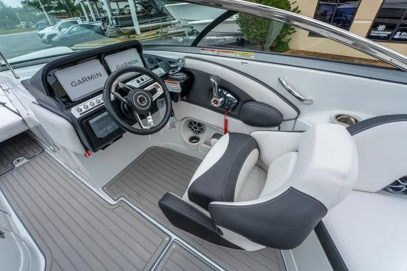 Slide: The Image of Interior of 2026 Crownline 318 XSS boat with modern steering and Garmin displays. - 25