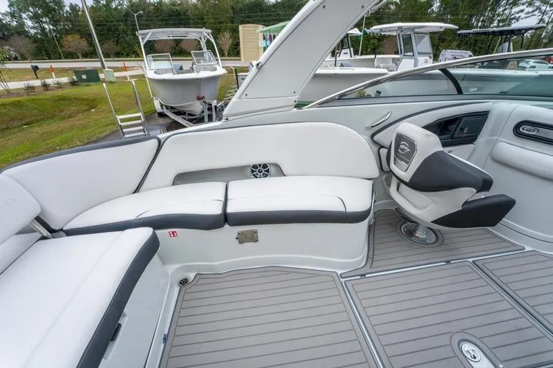 Slide: The Image of 2026 Crownline 318 XSS boat interior with sleek seating and modern helm design. - 27