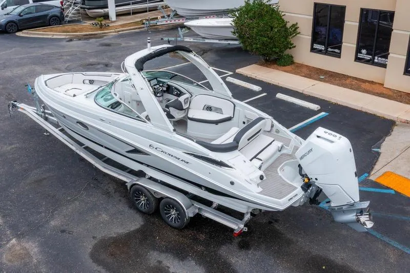 Slide: The Image of 2026 Crownline 318 XSS boat on trailer, parked in a lot, showcasing sleek design. - 3