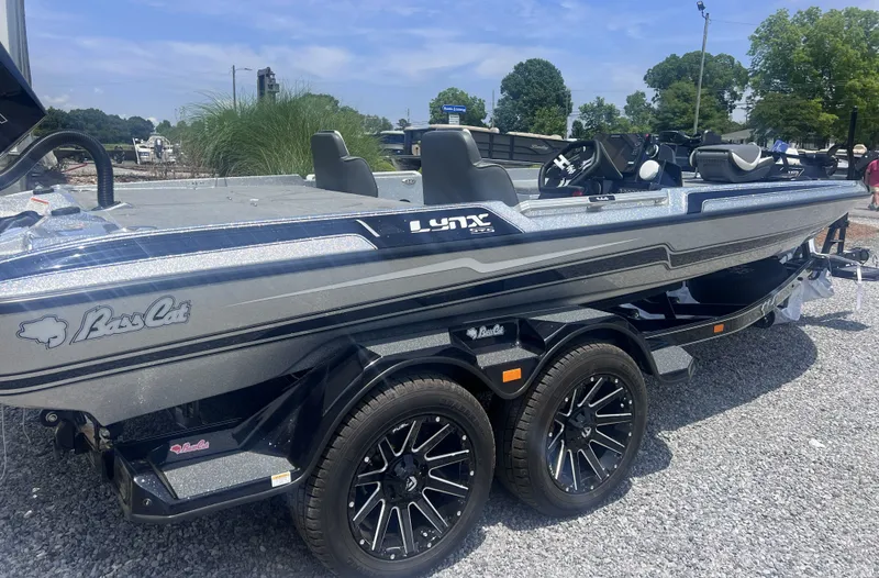 The Image of 2026 Bass Cat Lynx STS boat on gravel lot, side view. - 1