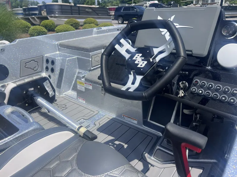Slide: The Image of Interior of 2026 Bass Cat Lynx STS boat with steering wheel and controls. - 5