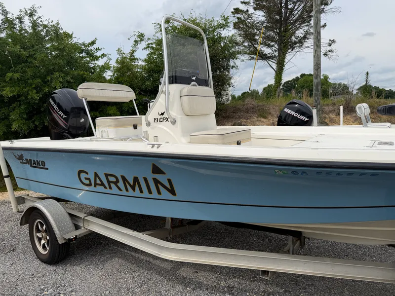 The Image of 2017 Mako Skiff 19 CPX boat on trailer, Garmin logo visible. - 1