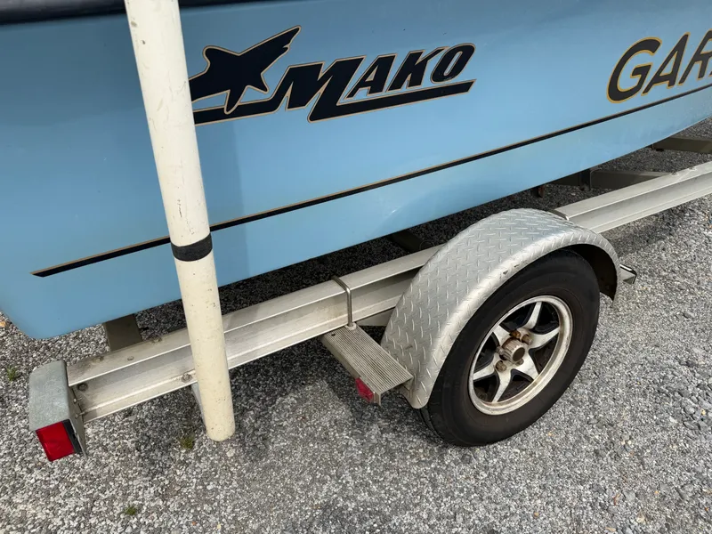 Slide: The Image of 2017 Mako Skiff 19 CPX boat on trailer, close-up view. - 23
