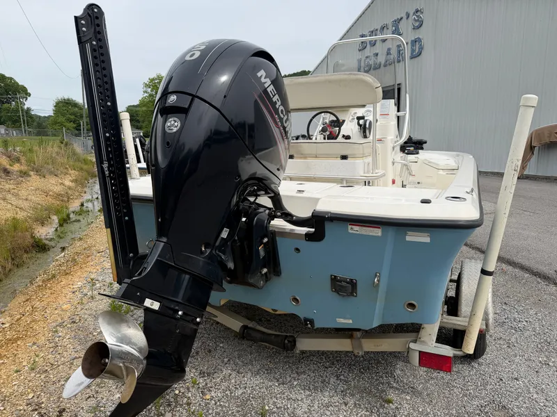 Slide: The Image of 2017 Mako Skiff 19 CPX with Mercury engine, parked on trailer. - 4