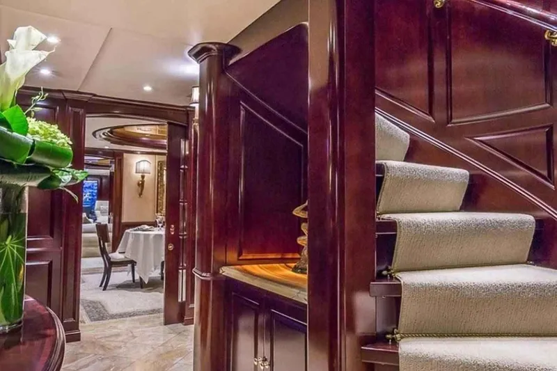 Slide: The Image of Luxurious interior of 2003 Trinity Yachts motoryacht with elegant wood paneling and staircase. - 13